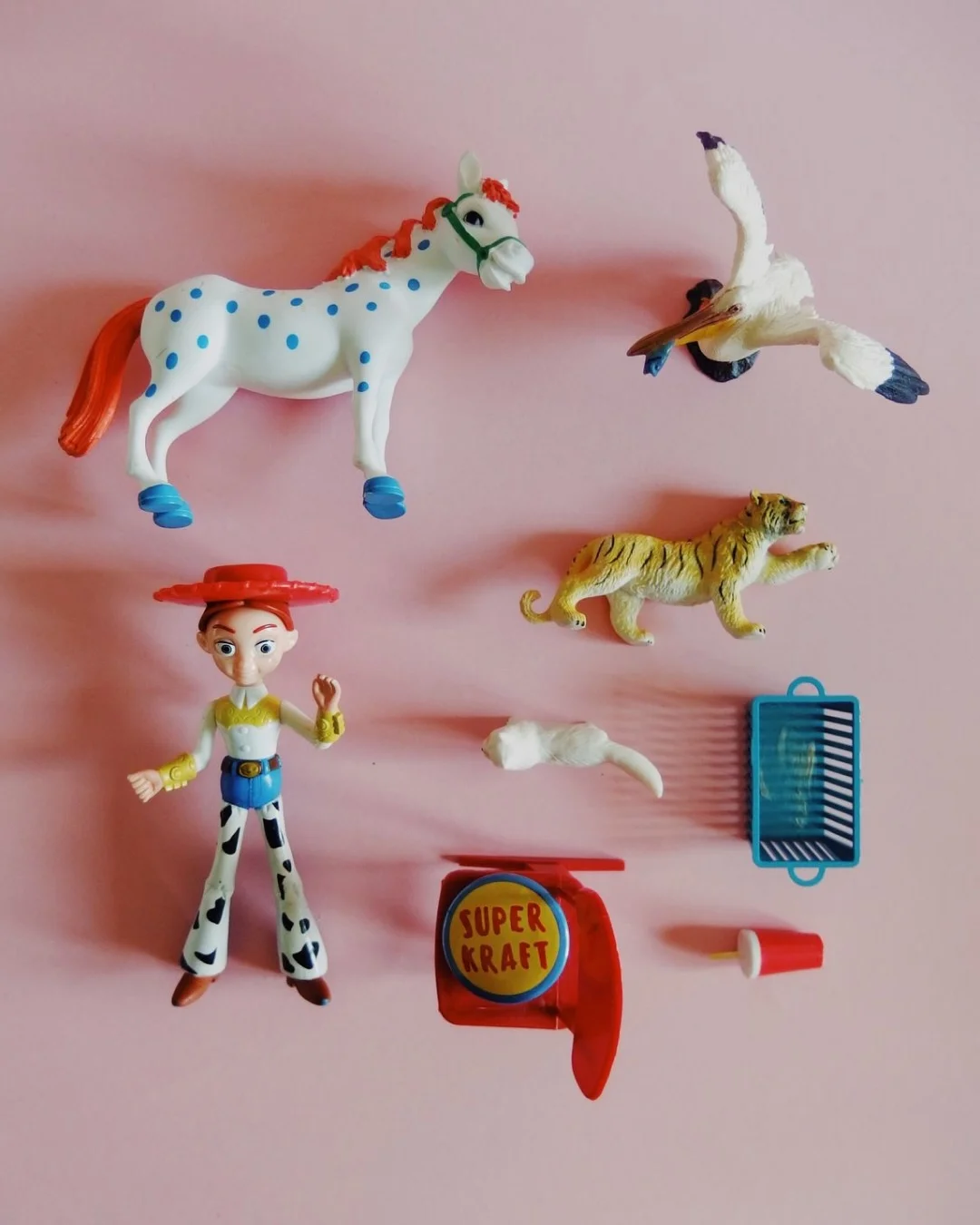 Instagram post: a flat lay of vintage toys on a pink background